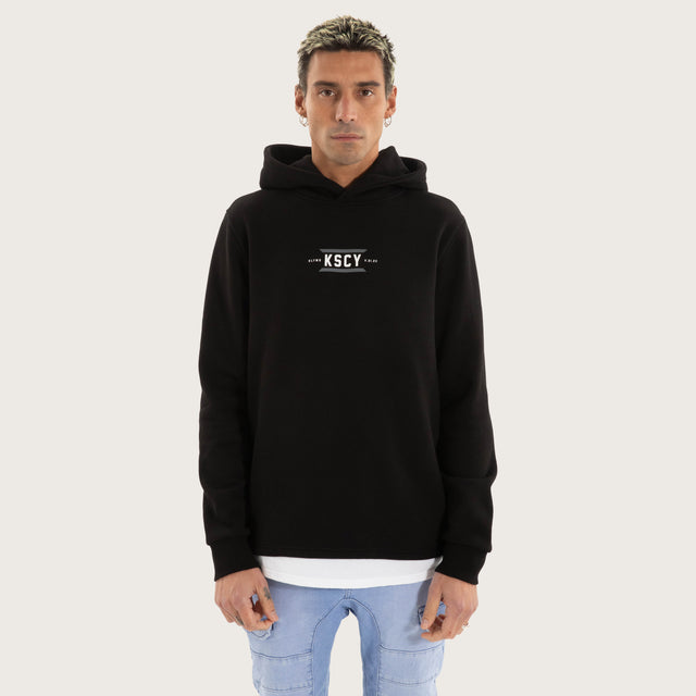 Model wears Beneath Layered Hoodie Jet Black Hoodies in Black - Image 3