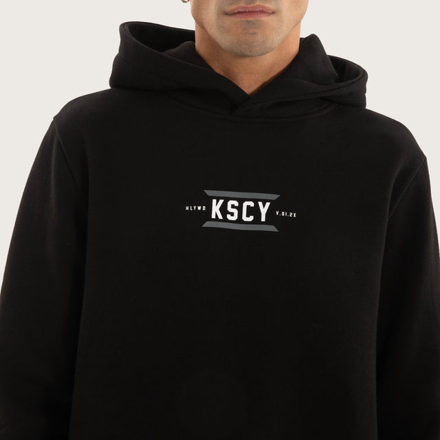 Model wears Beneath Layered Hoodie Jet Black Hoodies in Black - Image 5