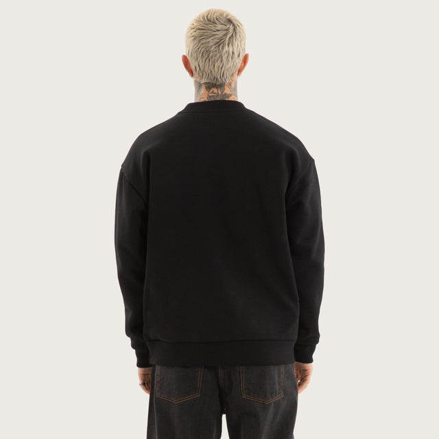 Model wears System Relaxed Sweater Jet Black Jumpers in Black - Image 3