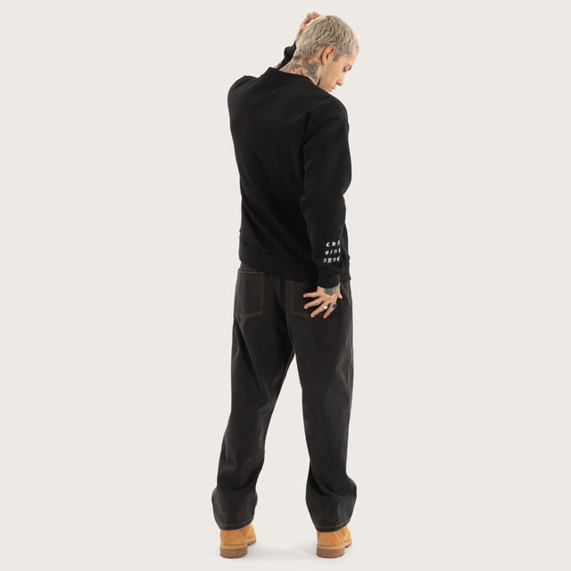 Model wears System Relaxed Sweater Jet Black Jumpers in Black - Image 4