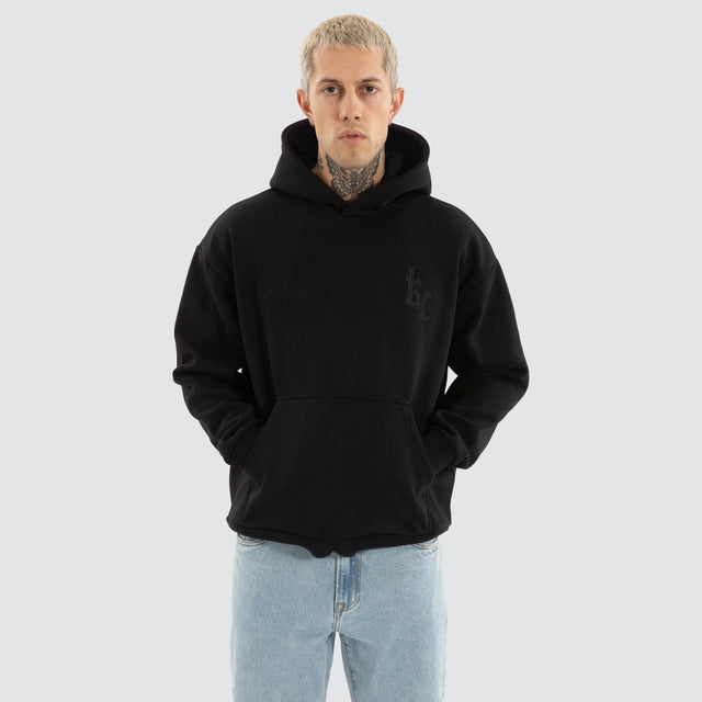 Model wears Chained Relaxed Hoodie Jet Black Hoodies in Black - Image 2