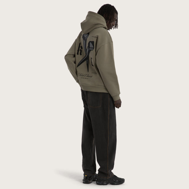 Model wears Nailed Relaxed Hoodie Khaki Hoodies in Green - Image 5