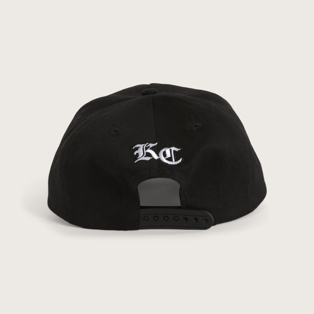Model wears Archer Cap Jet Black Headwear in Black - Image 3