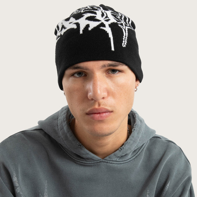 Model wears Obsidian Beanie Jet Black Headwear in Black - Image 2
