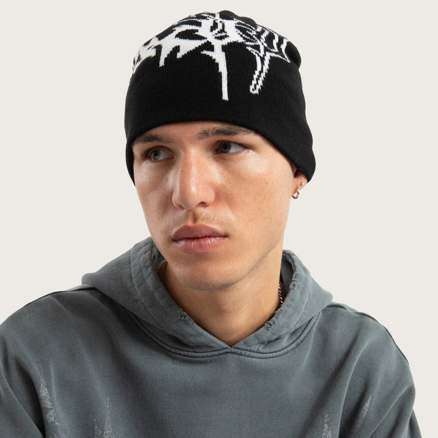 Model wears Obsidian Beanie Jet Black Headwear in Black - Image 3
