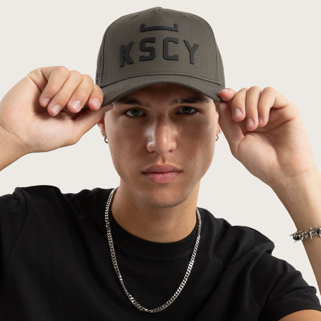 Model wears Divinity Cap Charcoal Caps in Grey - Image 5