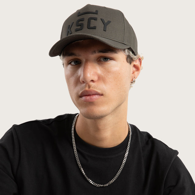 Model wears Divinity Cap Charcoal Caps in Grey - Image 6