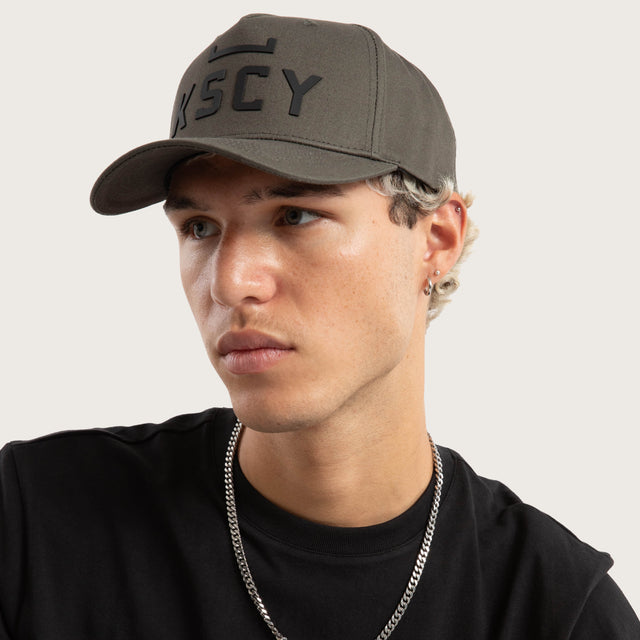 Model wears Divinity Cap Charcoal Caps in Grey - Image 7