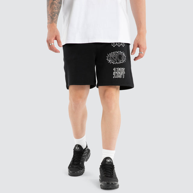 Model wears Unthought Track Short Anthracite Black Shorts in Black - Image 1