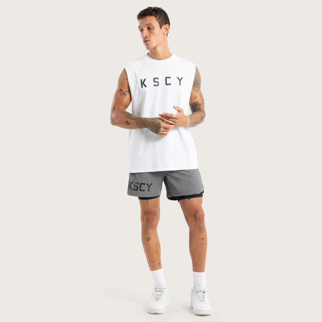 Model wears Vigor Split Hem Muscle Optical White Muscle Tees in White - Image 5