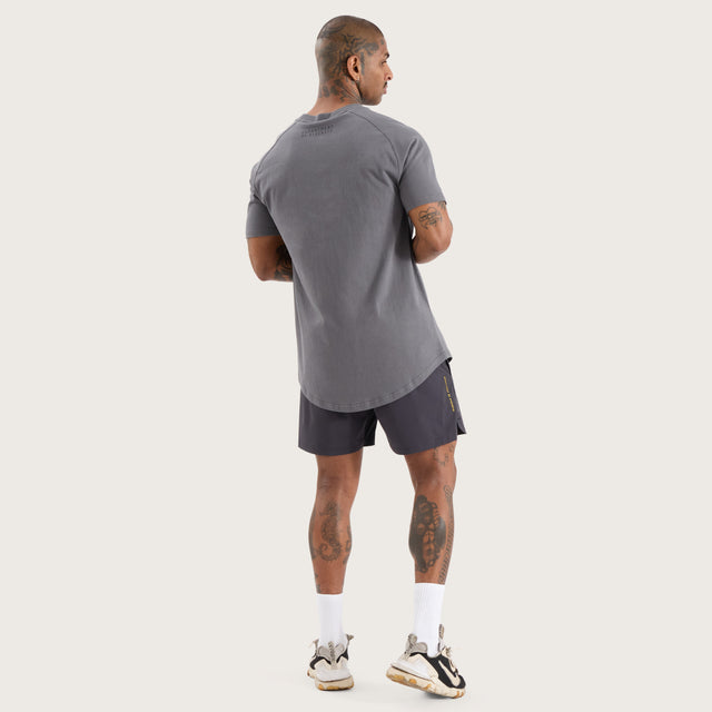 Model wears Vital Raglan Dual Curved Tee Charcoal T-Shirts in Grey - Image 7