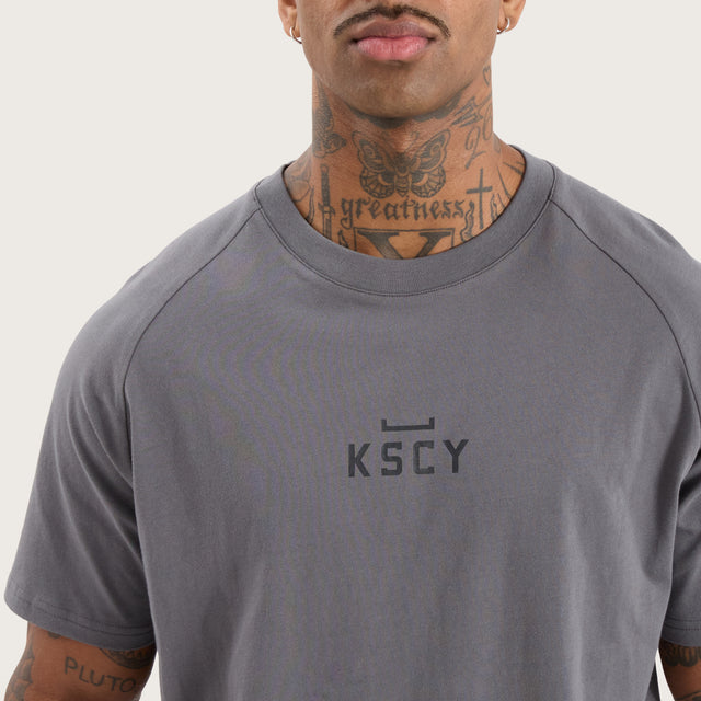 Model wears Vital Raglan Dual Curved Tee Charcoal T-Shirts in Grey - Image 3