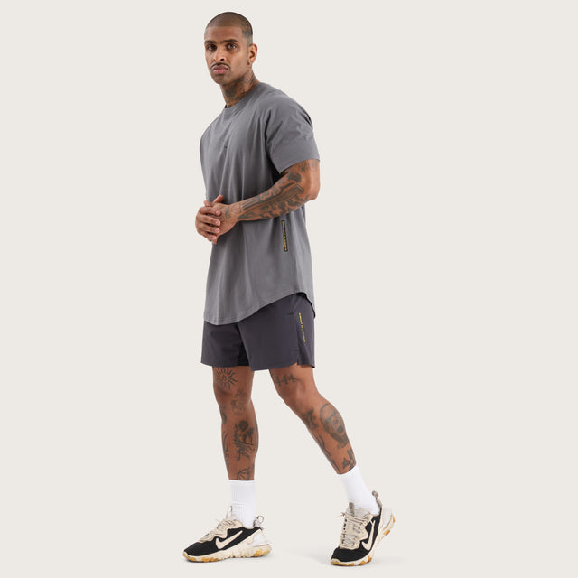 Model wears Vital Raglan Dual Curved Tee Charcoal T-Shirts in Grey - Image 2