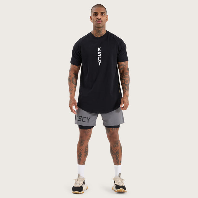 Model wears Venture Raglan Dual Curved Tee Jet Black T-Shirts in Black - Image 6