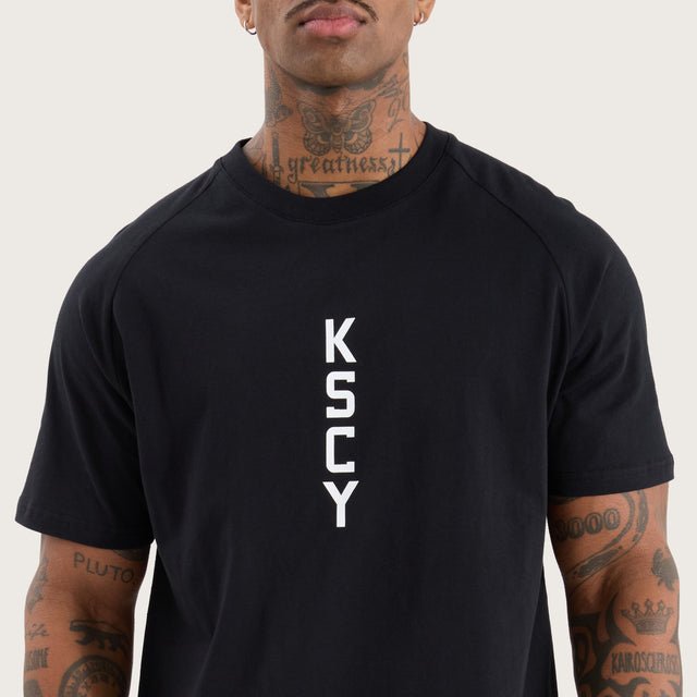 Model wears Venture Raglan Dual Curved Tee Jet Black T-Shirts in Black - Image 5
