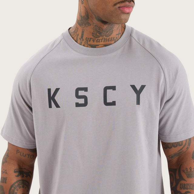 Model wears Rapid Raglan Dual Curved Tee Alloy T-Shirts in Grey - Image 4