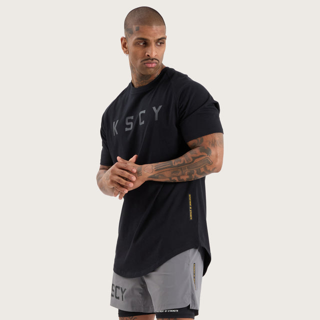 Model wears Rapid Raglan Dual Curved Tee Jet Black T-Shirts in Black - Image 2