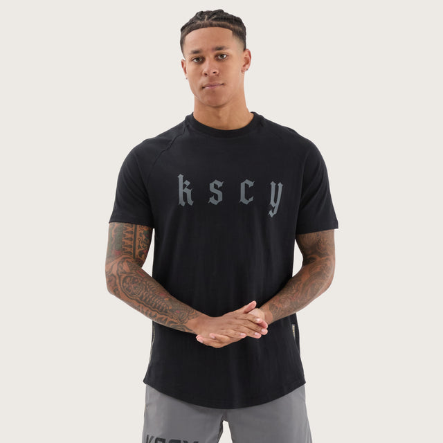 Model wears Apex Raglan Dual Curved Tee DOS Black T-Shirts in Black - Image 1