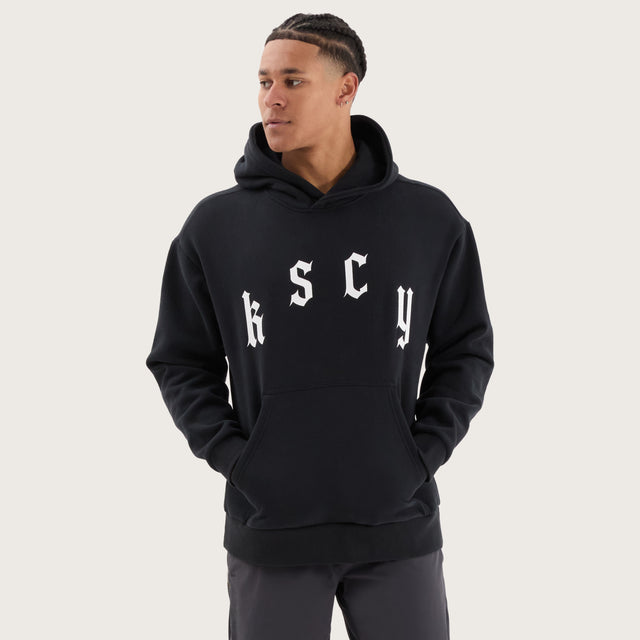 Model wears Stamina Relaxed Hoodie DOS Black Hoodies in Black - Image 1