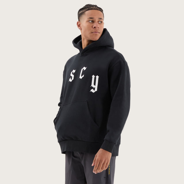 Model wears Stamina Relaxed Hoodie DOS Black Hoodies in Black - Image 5