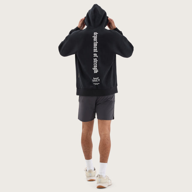 Model wears Stamina Relaxed Hoodie DOS Black Hoodies in Black - Image 7