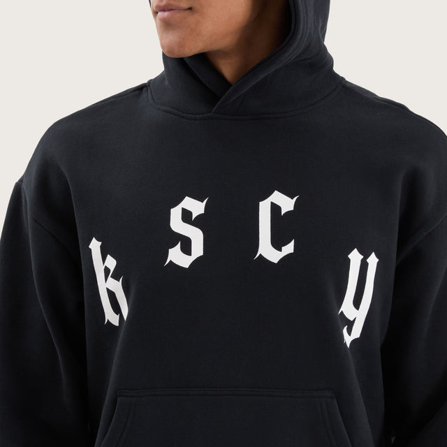 Model wears Stamina Relaxed Hoodie DOS Black Hoodies in Black - Image 3