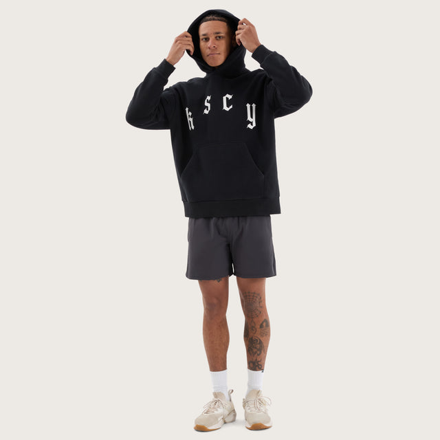 Model wears Stamina Relaxed Hoodie DOS Black Hoodies in Black - Image 6