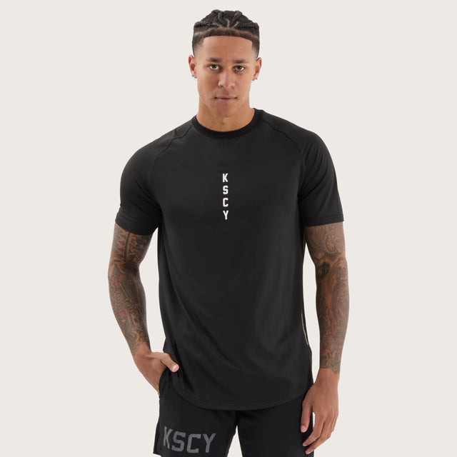 Model wears Fortify Raglan Dual Curved Active Tee Black/Asphalt T-Shirts in Black - Image 2