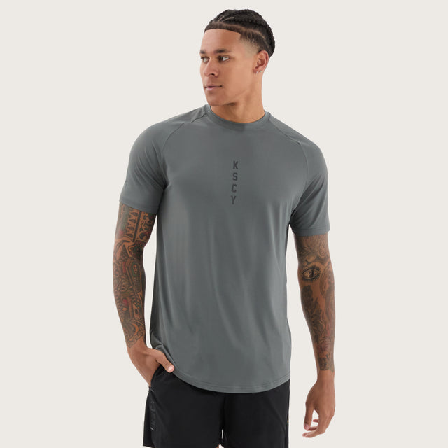 Model wears Fortify Raglan Dual Curved Active Tee Shadow/Jet Black T-Shirts in Grey - Image 2
