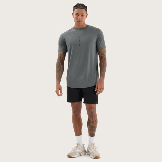 Model wears Fortify Raglan Dual Curved Active Tee Shadow/Jet Black T-Shirts in Grey - Image 5