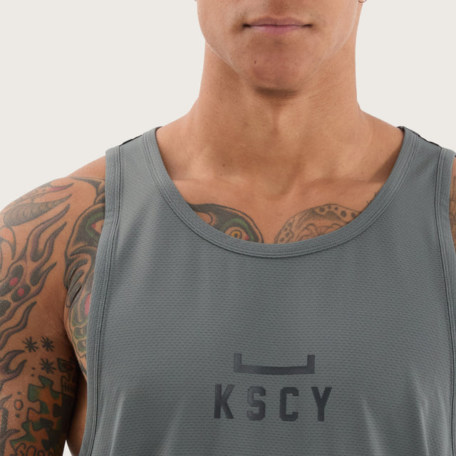 Model wears Bolster Curved Hem Active Tank Shadow/Jet Black Muscle Tees in Grey - Image 3