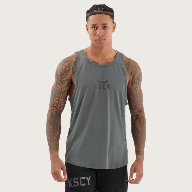 Model wears Bolster Curved Hem Active Tank Shadow/Jet Black Muscle Tees in Grey - Image 1