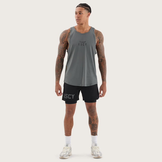 Model wears Bolster Curved Hem Active Tank Shadow/Jet Black Muscle Tees in Grey - Image 4