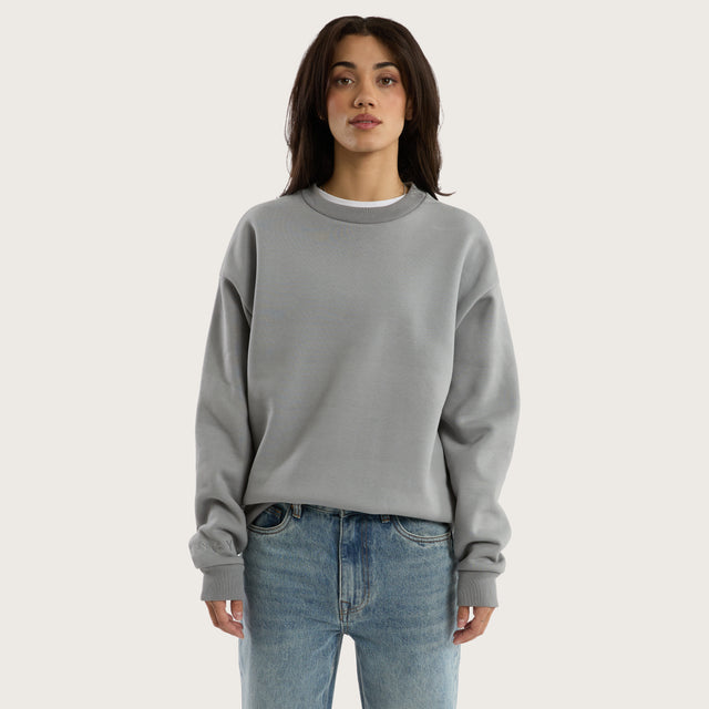 Model wears Medora Relaxed Sweater Pigment Ultimate Grey Jumpers in Grey - Image 4