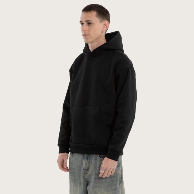 Model wears Weyburn Relaxed Hoodie Jet Black Hoodies in Black - Image 1