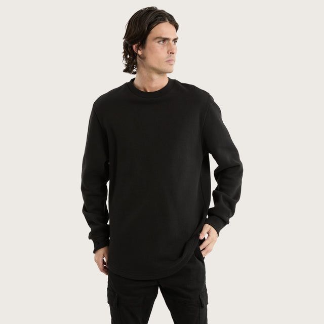 Model wears Miles Dual Curved Sweater Jet Black Jumpers in Black - Image 1