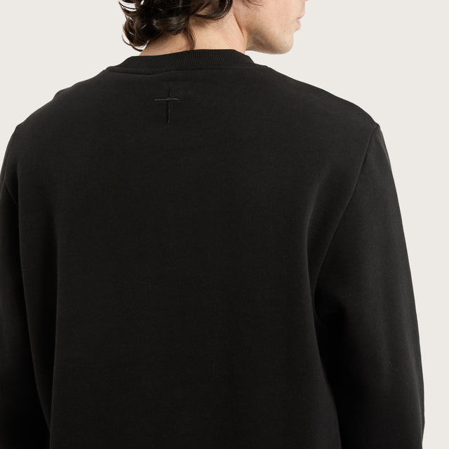 Model wears Miles Dual Curved Sweater Jet Black Jumpers in Black - Image 3