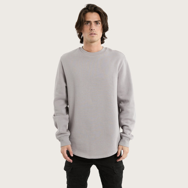 Model wears Miles Dual Curved Sweater Gull Jumpers in Grey - Image 1