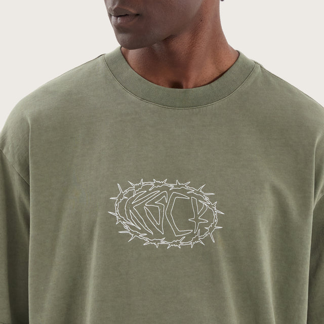 Model wears Adrift Oversized Tee Pigment Olive T-Shirts in Green - Image 3