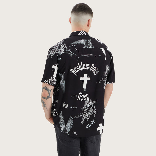 Model wears Blackford Relaxed Shirt Cross Angel Print Short Sleeve Shirts in Black - Image 1