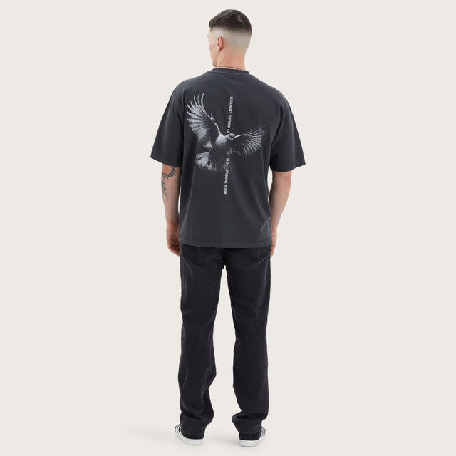 Model wears Wissle Oversized Tee Pigment Black T-Shirts in Black - Image 5