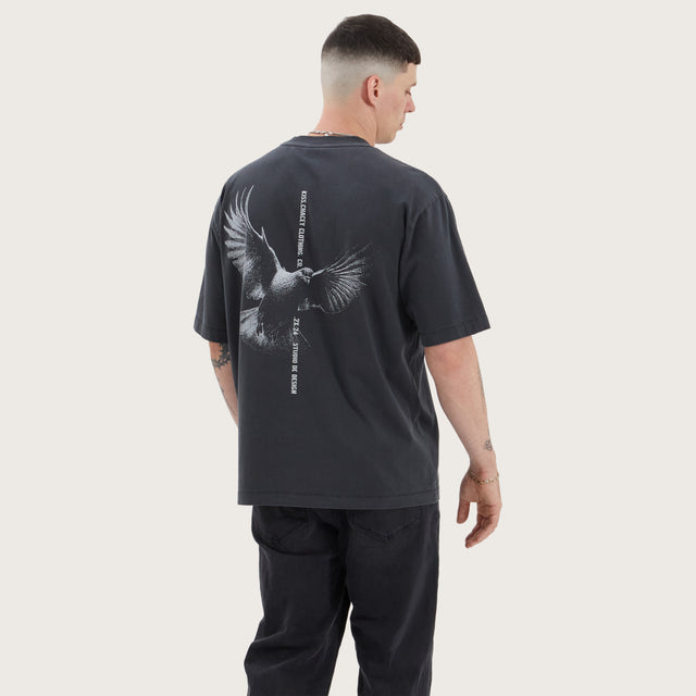 Model wears Wissle Oversized Tee Pigment Black T-Shirts in Black - Image 1