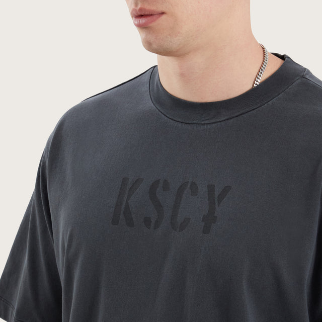 Model wears Wissle Oversized Tee Pigment Black T-Shirts in Black - Image 3
