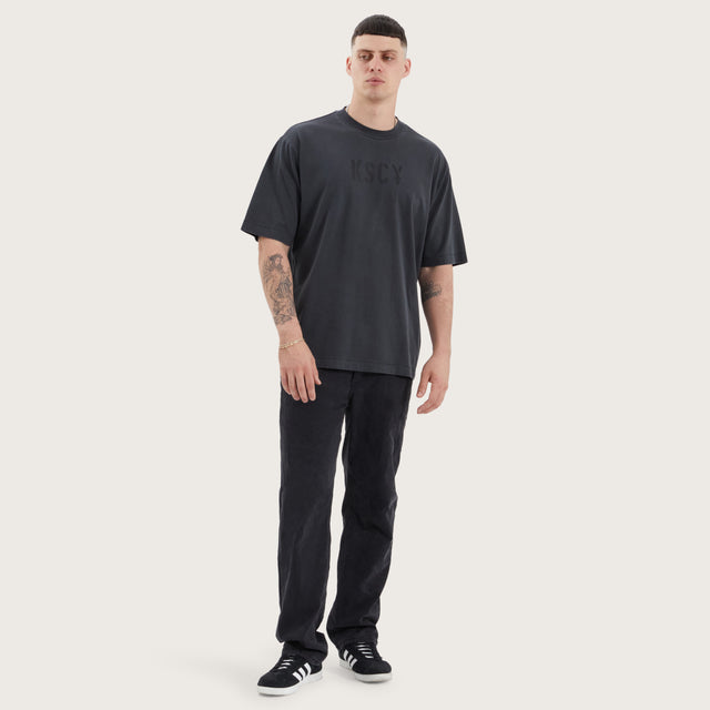 Model wears Wissle Oversized Tee Pigment Black T-Shirts in Black - Image 4