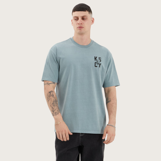 Model wears Untamed Box Fit Tee Pigment Lead T-Shirts in Green - Image 7