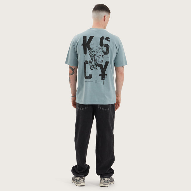 Model wears Untamed Box Fit Tee Pigment Lead T-Shirts in Green - Image 6