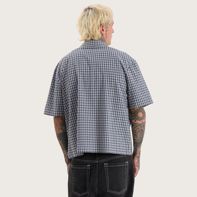 Model wears Skylar Oversized Dress Shirt Blue Check Short Sleeve Shirts in Blue - Image 4