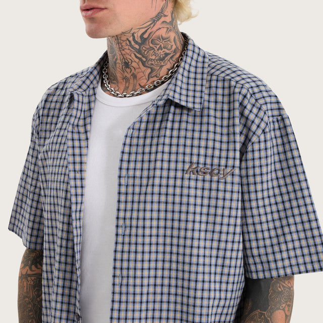 Model wears Skylar Oversized Dress Shirt Blue Check Short Sleeve Shirts in Blue - Image 3