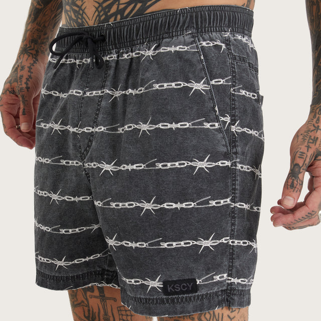 Model wears Trevor Beach Short Chain Print Shorts in Black - Image 3
