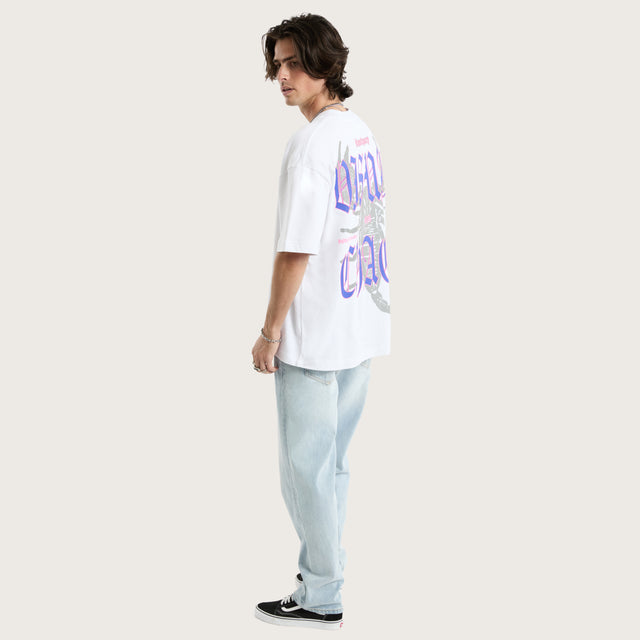 Model wears Scorpio Street Tee Optical White T-Shirts in White - Image 5